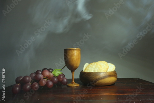 Holy communion on wooden table on church.Taking holy Communion.Cup of wood with red wine, bread.The Feast of Corpus Christi Concept. photo