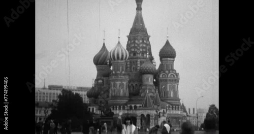 Gingerbread House on Red Square. St. Basil's Cathedral in 1980s Moscow city, Russia. People walk, visit famous travel architecture destination. Archival vintage black white film. Old retro archive photo