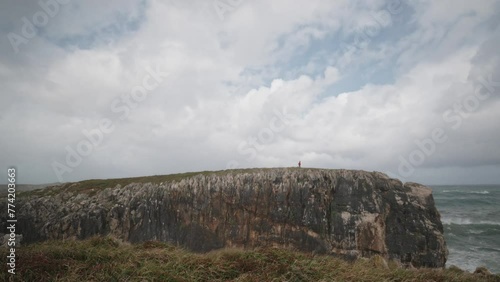 Wallpaper Mural Lone Runner on Cliff Edge Against Expansive Sky, outdoor training Torontodigital.ca