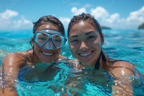 Two cheerful young adults with snorkeling gear posing in the crystal-clear sea under bright sunlight © Larisa AI