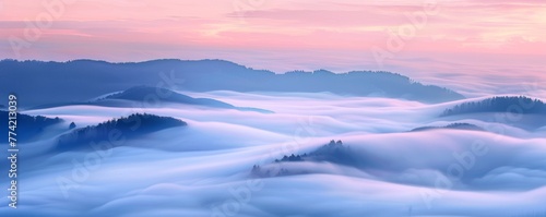 Waves of fog roll over hills at dawn photo