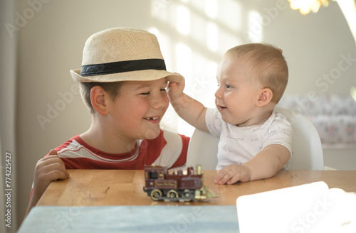 Smily brothers are play togather.  Family with children at home. Love, trust and tenderness