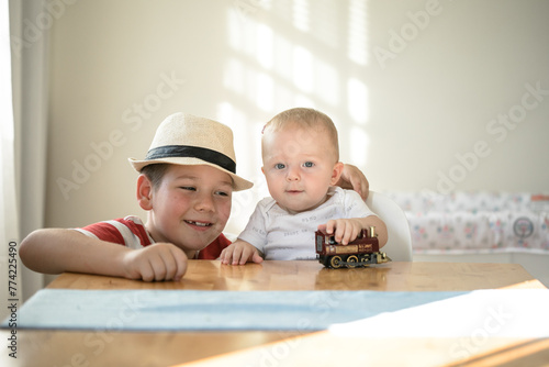 Smily brothers are play togather.  Family with children at home. Love, trust and tenderness