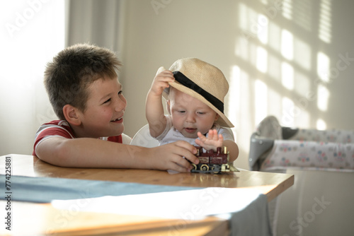 Smily brothers are play together. Family with children at home. Love, trust and tenderness