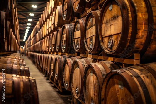 Numerous wooden barrels stacked on top of each other in a temperature-controlled barrel aging room for beer © Ilia Nesolenyi