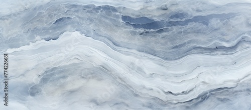 Marble surface showcasing intricate patterns under a clear blue sky in the distance