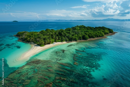 Aerial view of a tropical island surrounded by the vast ocean, featuring palm-fringed beaches and coral reefs