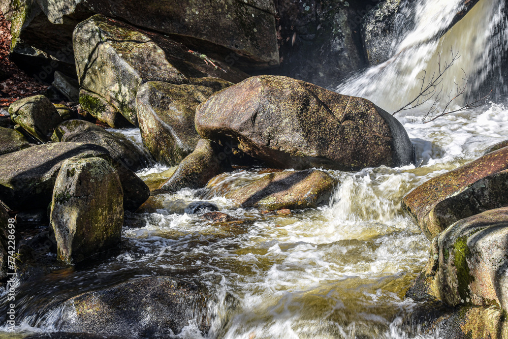 water cascading over rocks  at willard  brook  on a winters day