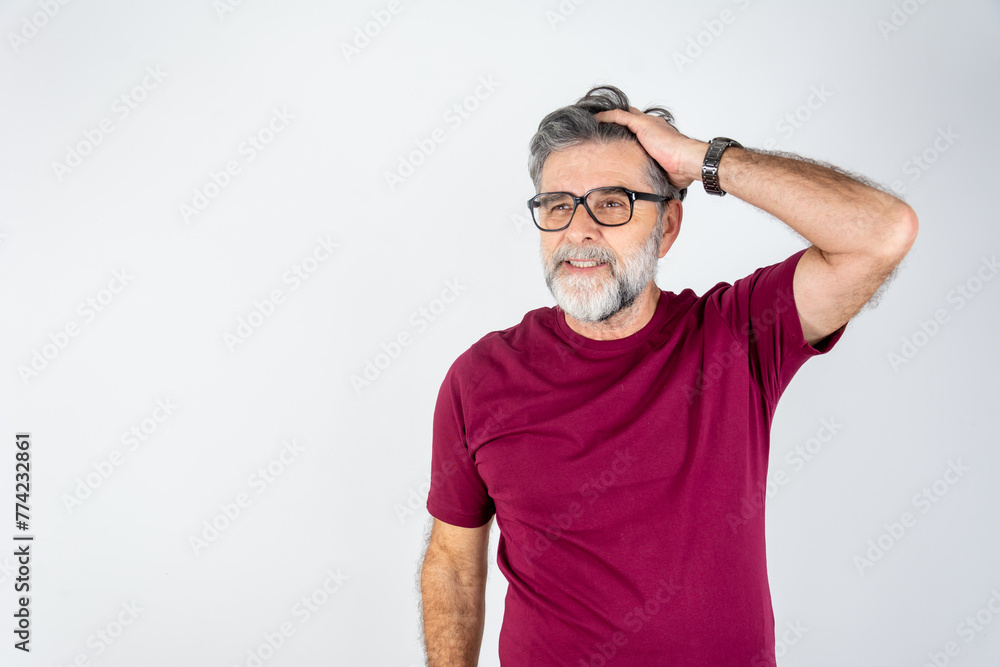 Smiling successful confident mature bearded casual business man wearing red t-shirt holding hands in hair isolated on grey color background studio portrait. Achievement career wealth concept Smiling successful confident mature bearded casual business man wearing red t-shirt holding hands in hair isolated on grey color background studio portrait. Achievement career wealth concept
