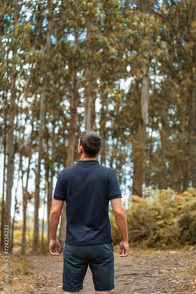 Background of a young man enjoying the forest alone during his vacation