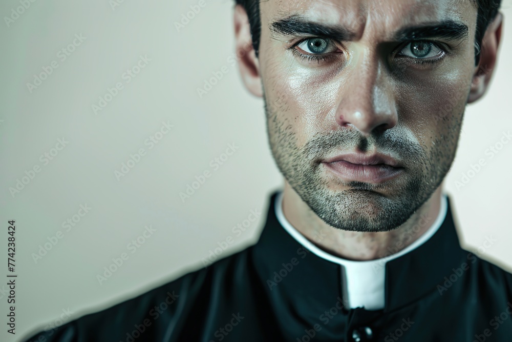 Fototapeta premium Young priest on grey background