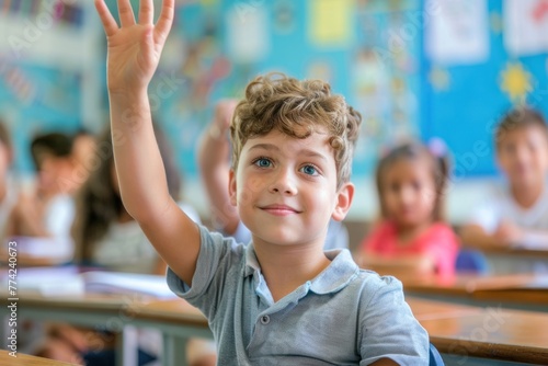 Small boy kid in school classroom raising hand up to answer teacher