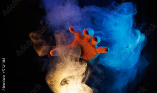 Mystical smoke in scary hands. Mysterious composition. Fortune teller, mind power, prediction, halloween concept. Wide angle horizontal wallpaper or web banner. Mockup for your logo. © KDdesignphoto