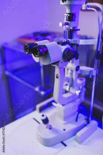 Fototapeta Naklejka Na Ścianę i Meble -  A modern microscope for vision testing in a light room. Microscope for vision correction.