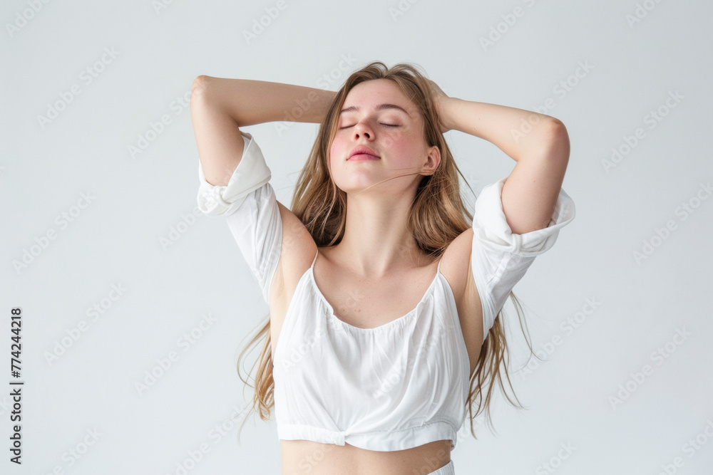Fototapeta premium Happy Relaxed Woman with Arms Behind Head, Long Curly Hair, White Background