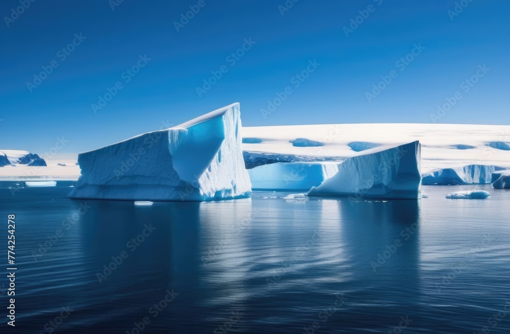 Large icebergs in the sea with reflection on the water on a sunny day