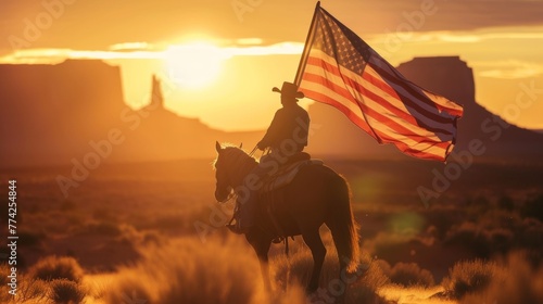 Cowboy on horseback carrying a US national flag © Joyce