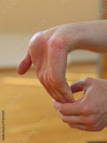 Man doing wrist stretching exercises close up
