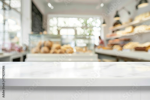 Blurred white marble counter in front of a blurred bakery shop interior showing customers, pastries and shelves displaying products with a background banner leaving space for copy. Display montage.