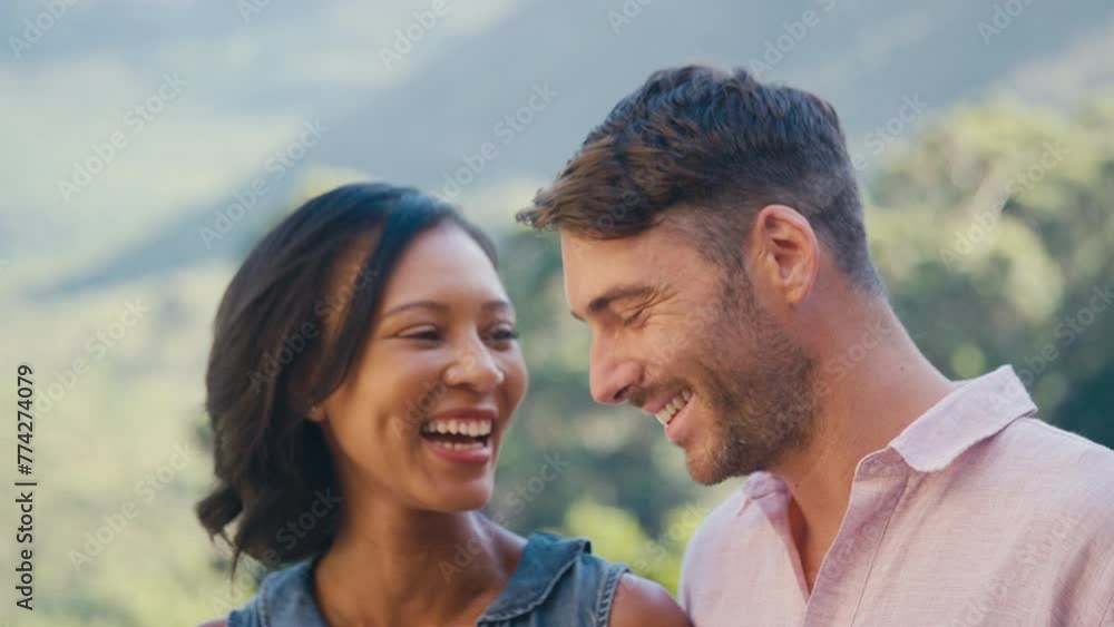 Portrait of laughing and smiling multi-racial couple standing outdoors in countryside - shot in slow motion Portrait of laughing and smiling multi-racial couple standing outdoors in countryside - shot in slow motion