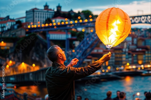 Vibrant Porto Nights: Portuense Joins São João Festivities, Launching Balloons in the City with D. Luis bridge at background © Mr. Bolota