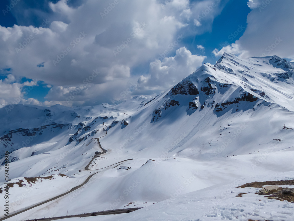 Grossglockner high alpine road going along majestic snow covered mountain peaks in High Tauern National Park, Carinthia Salzburg, Austria. Remote high altitude landscape in Austrian Alps. Nature lover