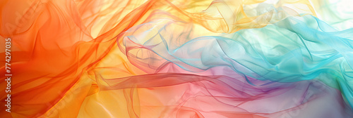 A lightweight flowing fabric with a gradient of orange, pink, and blue colors. photo