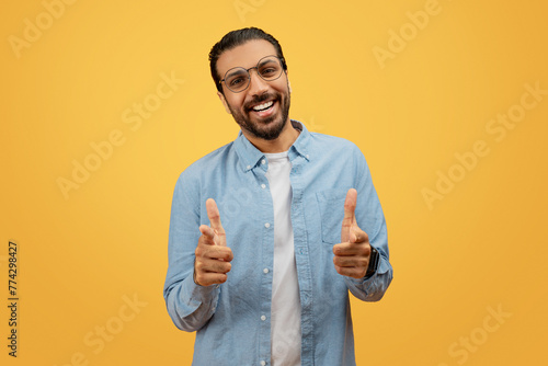 Man with direct camera gaze giving thumbs up