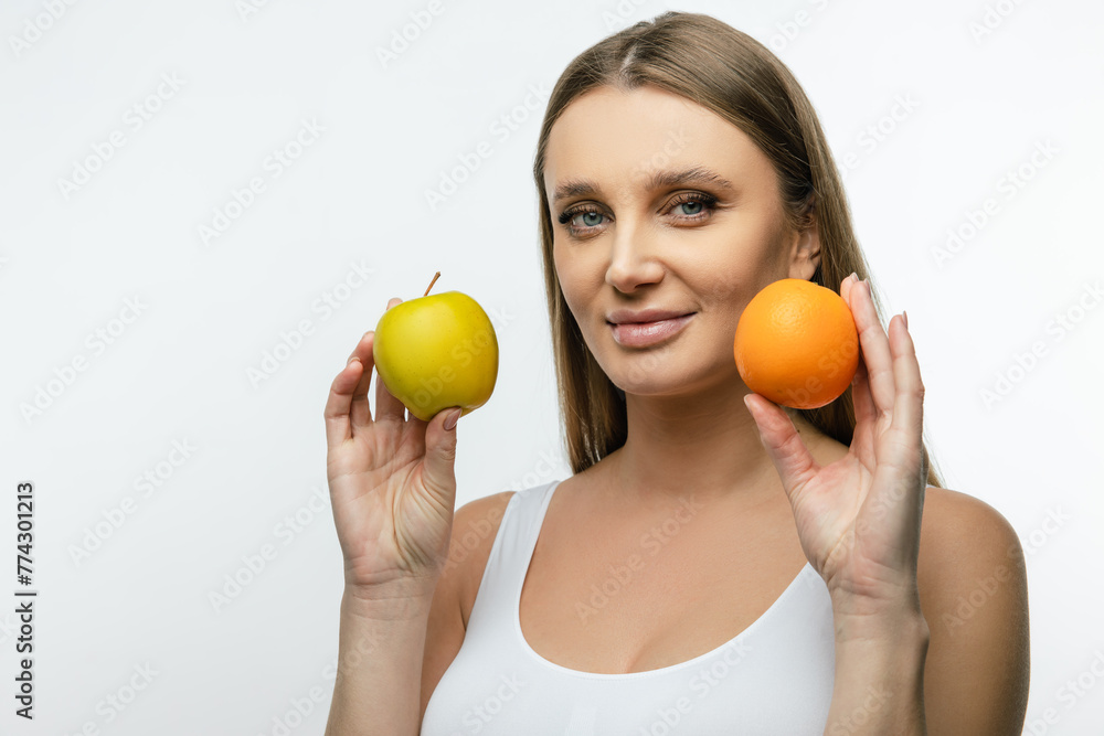 Waist up of a young woman with fruits in hands Waist up of a young woman with fruits in hands