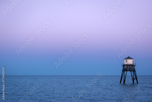 Lighthouse in the sea, Dovercourt low lighthouse at high tide built in 1863 and discontinued in 1917 and restored in 1980 the 8 meter lighthouse is still a iconic sight after sunset photo