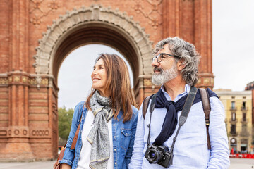 Mature married couple enjoying vacation visiting european city. Senior tourist walking in Barcelona during summer holidays.