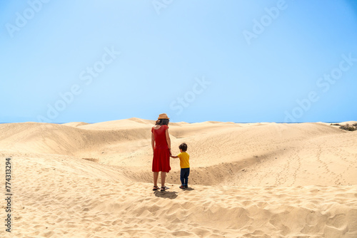 Mother and son on vacation very happy in the dunes of Maspalomas, Gran Canaria, Canary Islands