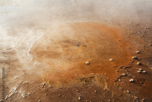 Close up view of a small orange geyser in Tatio geysers in the Atacama desert, Chile photo