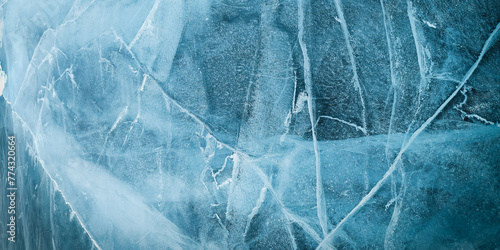 Abstract natural ice texture. Freezy ice surface. Blue backdrop with cracks and scratches on frozen water. Banner.