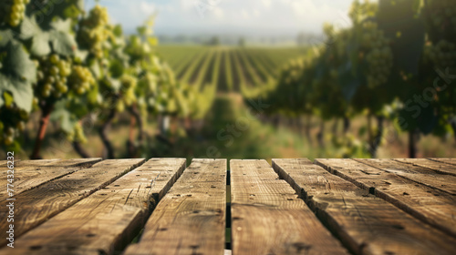 Empty wooden table top with blurred vineyard landscape on background. Mockup for wine products. Agriculture winery and wine tasting concept. Space for text.