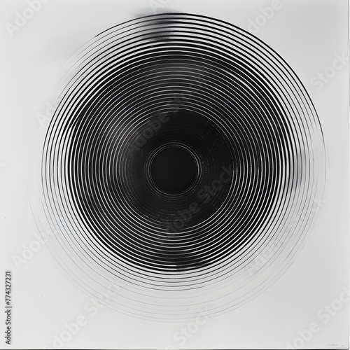 A black circle with a white background. The circle is blurry and has a lot of lines. The image is abstract and has a sense of movement