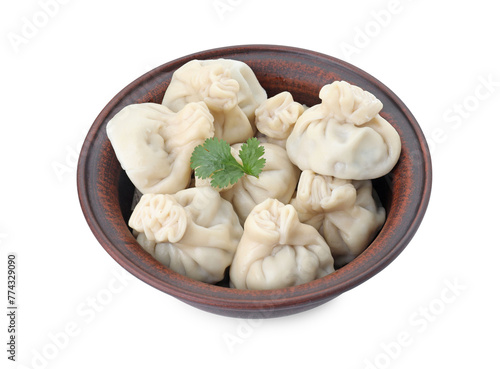 Many tasty khinkali (dumplings) and parsley in bowl isolated on white. Georgian cuisine