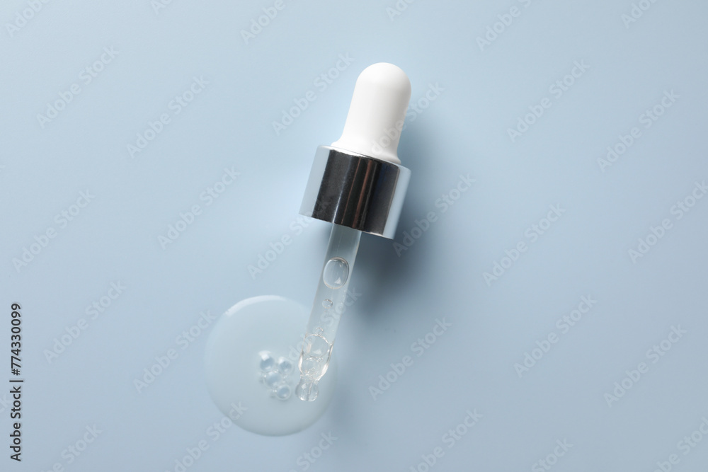 Pipette with moisturizing serum on light grey background, top view. Space for text Pipette with moisturizing serum on light grey background, top view. Space for text