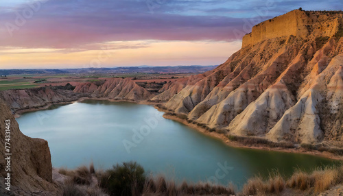 River and desert land in a canyon with enchanting twilight colors in the sky