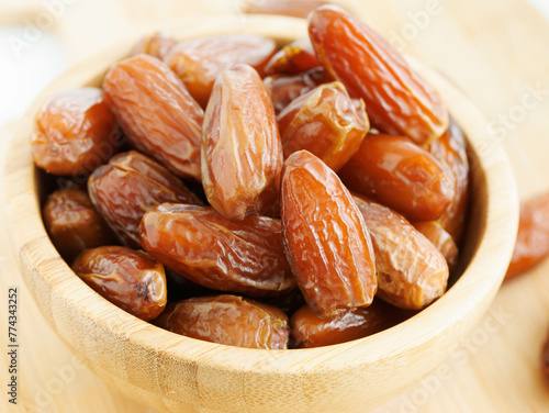 Several small dates in brown bowl