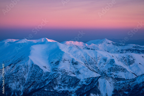 Sunset over snowy mountains