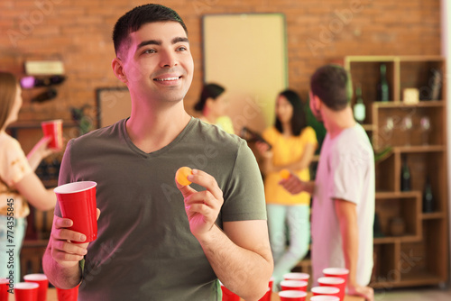 Young man with cup and ball...