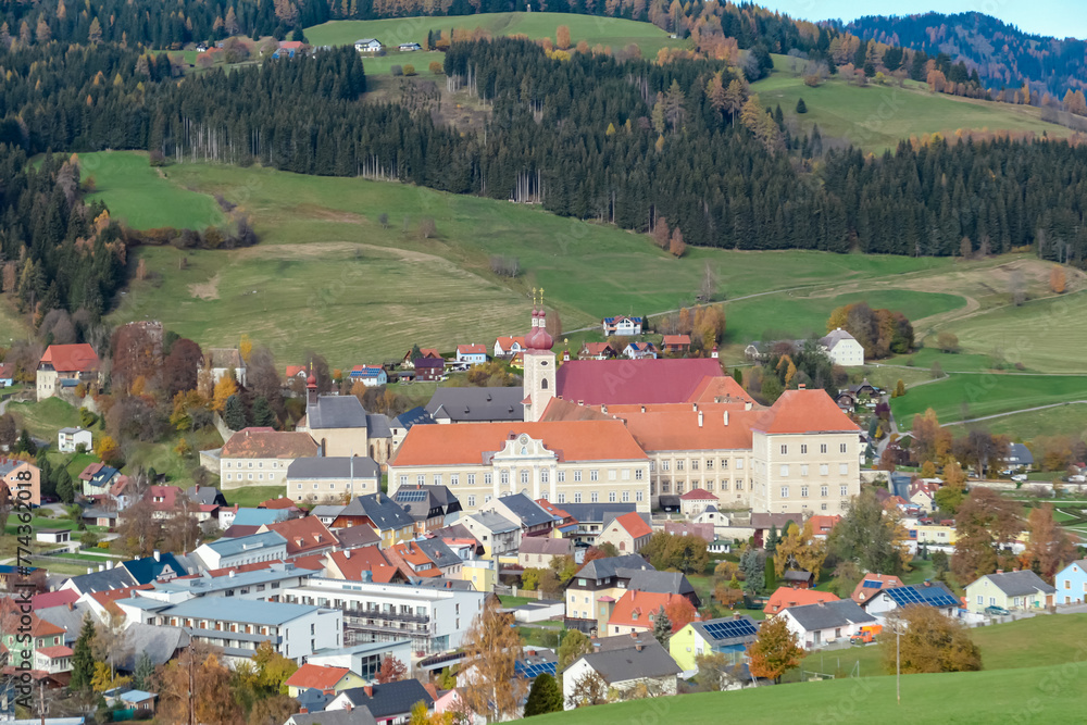 Benedictine monastery Saint Lambrecht Abbey surrounded by lush green alpine landscape in nature park Zirbitzkogel-Grebenzen, Gurktal Alps, Styria, Austria. Serene atmosphere. Austrian Alps in autumn