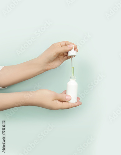 woman applying serum, lotion to her face