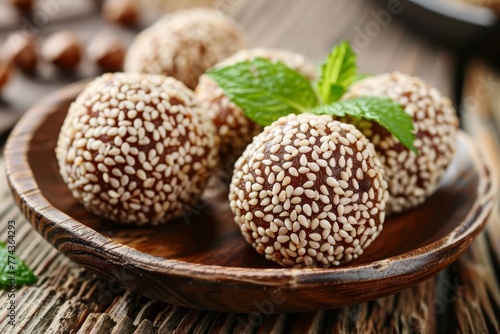 Closeup of tasty sesame balls with red bean paste on wooden surface