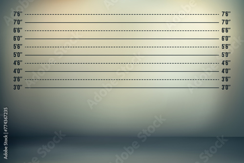 A dark wall with height markings in feet and an ominous backlight