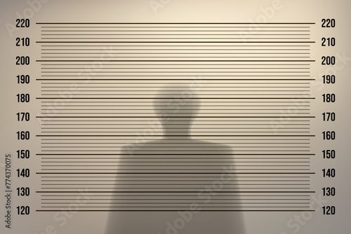 Mugshot in a police station with a retro background with backlight on an old wall and the shadow of a man