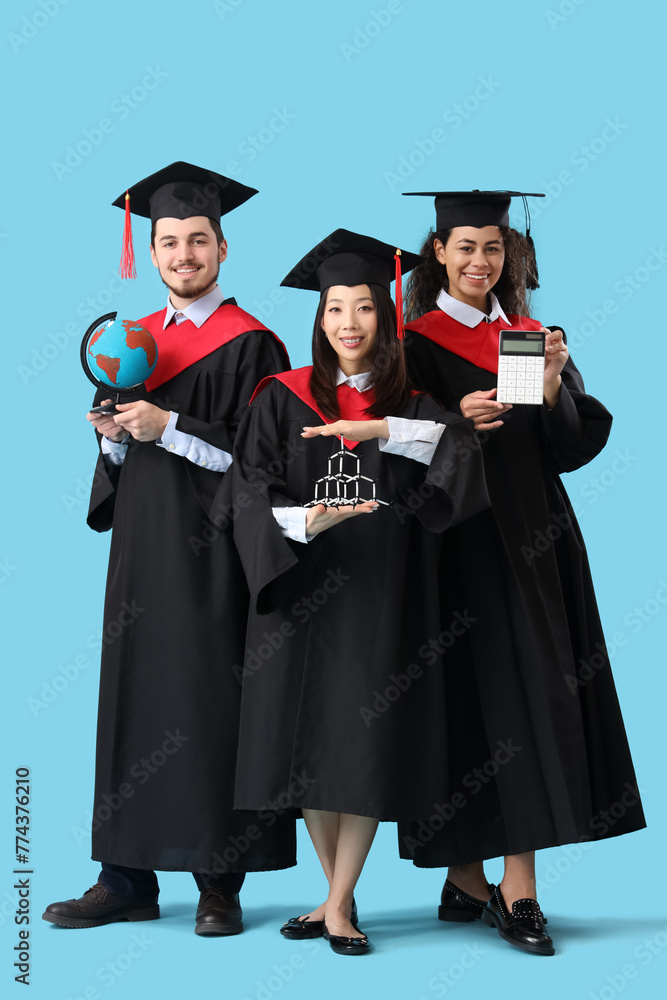 Graduate students with globe, calculator and molecular model on blue background Graduate students with globe, calculator and molecular model on blue background