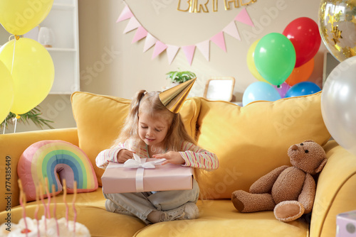 Cute little girl sitting on...