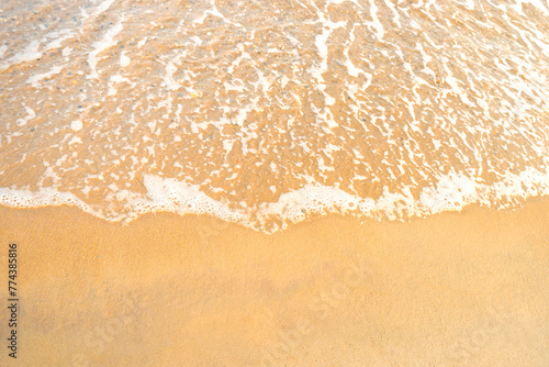 Beach sand and sea wave with foam, beach background